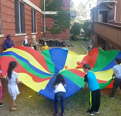 Kids playing outside with large canopy
