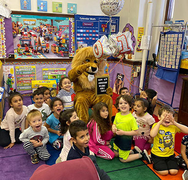 Students with a person in lion costume