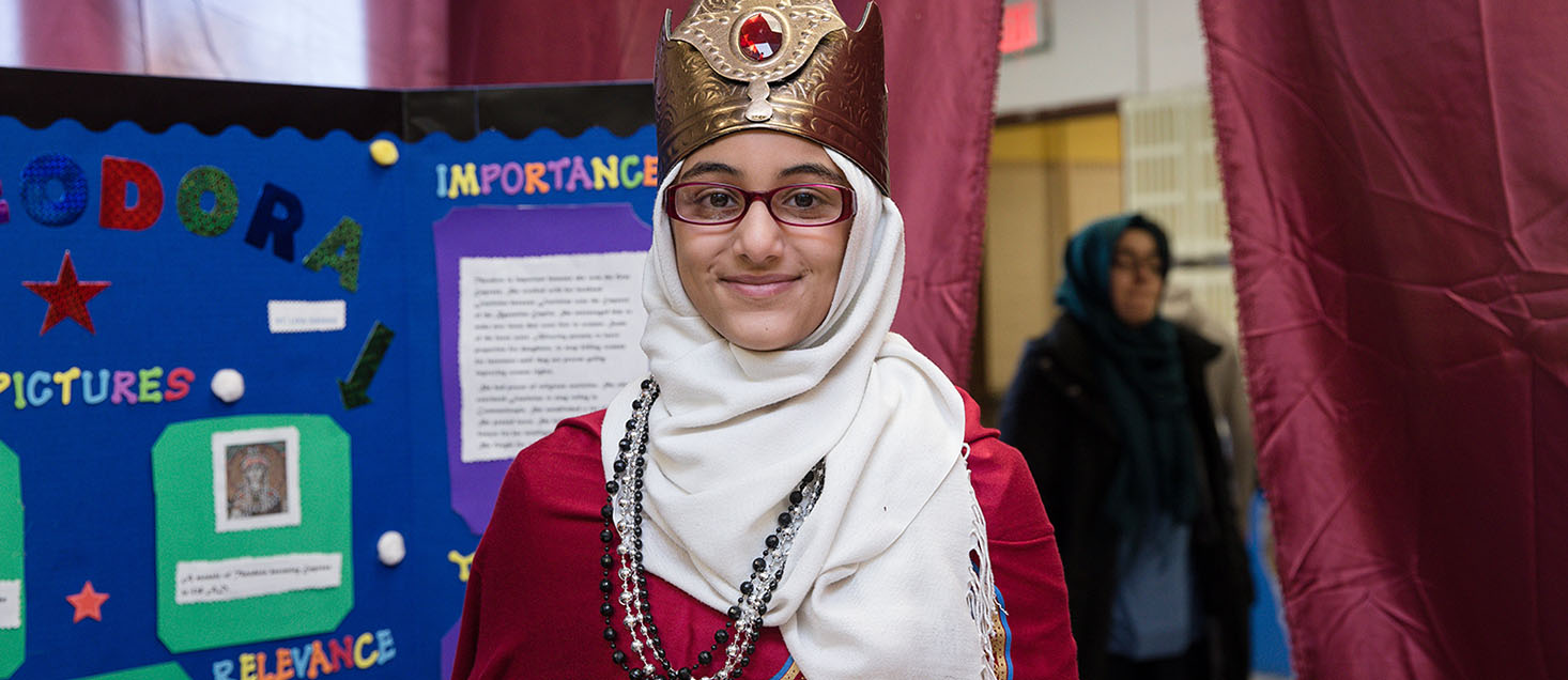 Girl smiling in front of presentation board