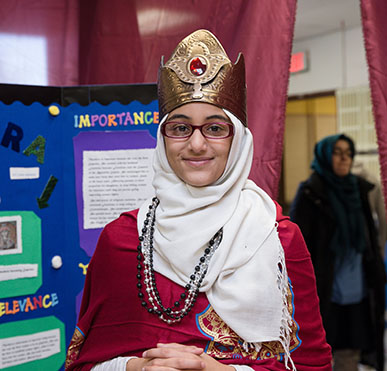 Girl smiling in front of presentation board