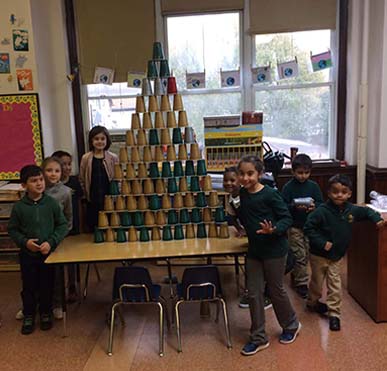 Students stacking cups in pyramid